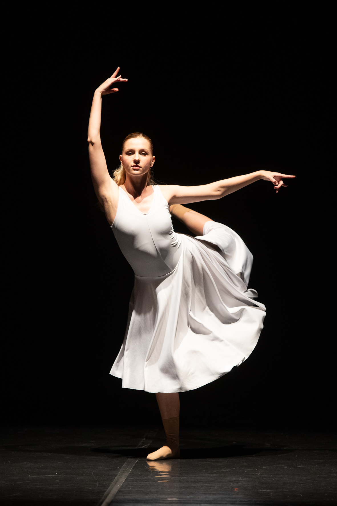 una danzatrice esegue una posizione tipica della danza classica